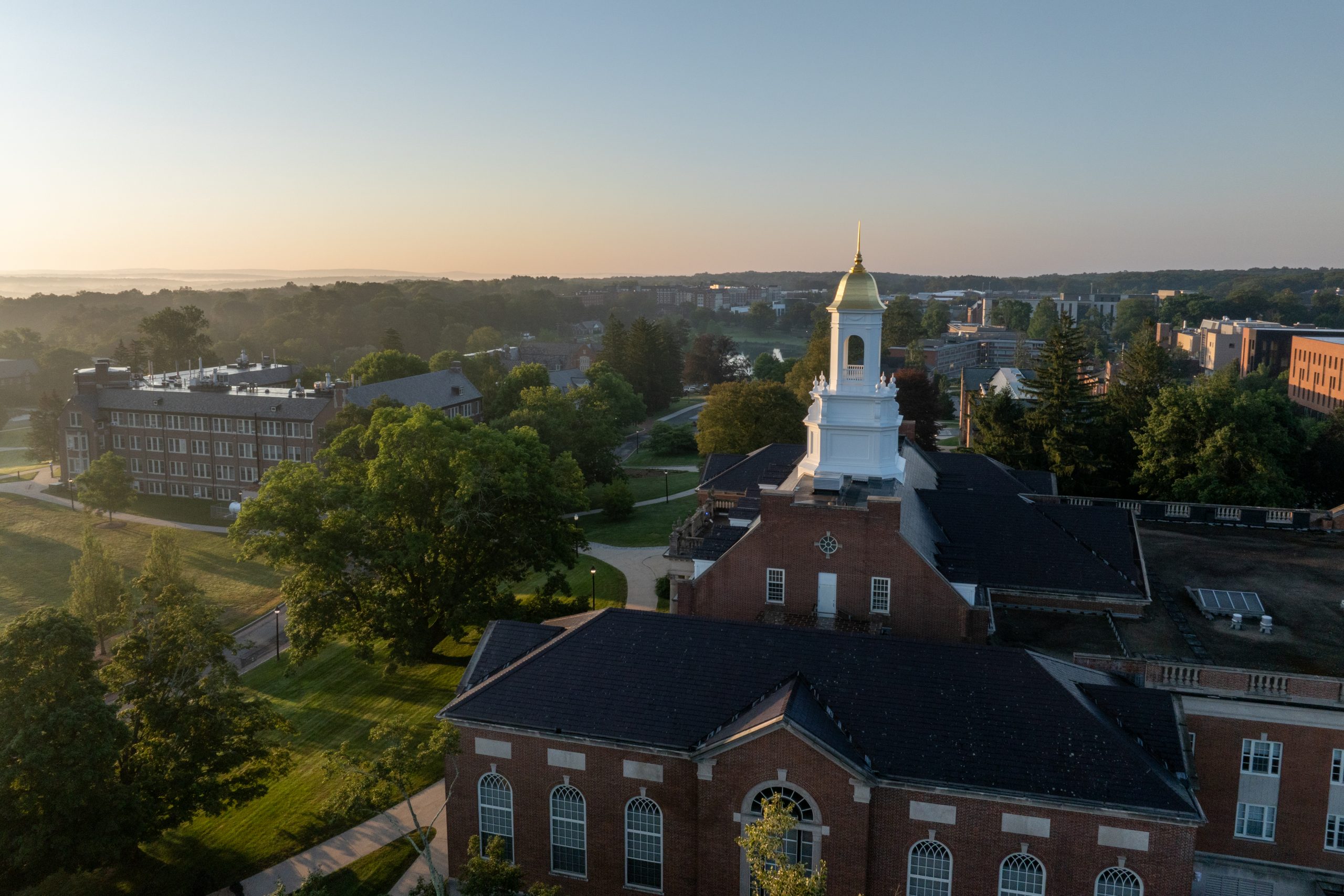 The sun rises on the Wilbur Cross cupola and the UConn Storrs campus